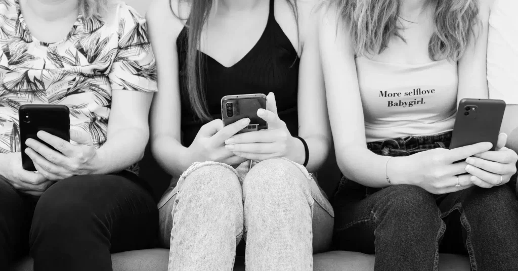 Girls operating Mobile Phones