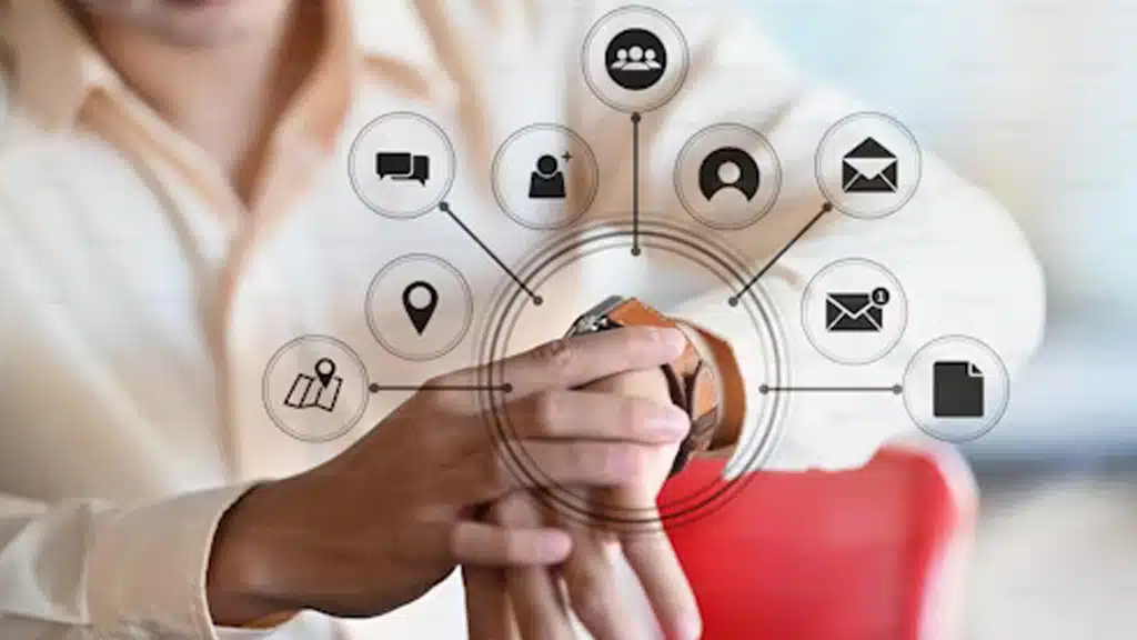 Close-up of a person checking a smartwatch, surrounded by icons representing communication, emails, and location services.