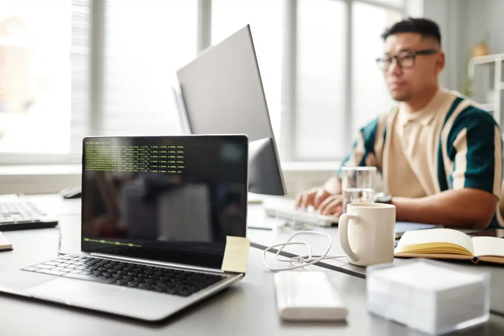 A man working diligently at a desk with a laptop, showcasing a professional environment.