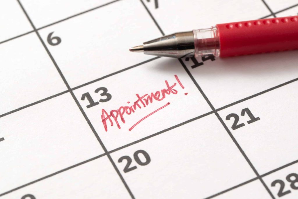 Appointment reminder written on calendar in red marker